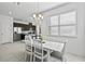 Open dining area with elegant lighting, seamlessly connected to a modern kitchen space at 13712 Summerport Village Pkwy, Windermere, FL 34786