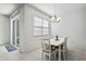 Bright and modern dining area featuring a stylish chandelier and sliding glass door at 13712 Summerport Village Pkwy, Windermere, FL 34786
