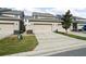 Townhome featuring two-car garage, well-maintained landscaping and neutral exterior paint at 13712 Summerport Village Pkwy, Windermere, FL 34786