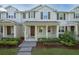 Well-manicured lawn and covered porch enhance this inviting townhome's curb appeal at 13712 Summerport Village Pkwy, Windermere, FL 34786