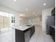 Kitchen with a large center island, stainless appliances, and backyard access at 13712 Summerport Village Pkwy, Windermere, FL 34786