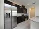 Modern kitchen featuring stainless steel appliances and dark wood cabinets at 13712 Summerport Village Pkwy, Windermere, FL 34786