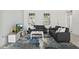 Comfortable living room featuring ample seating, a modern entertainment center, and neutral tones at 13712 Summerport Village Pkwy, Windermere, FL 34786
