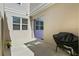 Private patio featuring a sliding glass door, flower pot, and grill at 13712 Summerport Village Pkwy, Windermere, FL 34786