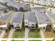 An aerial view of modern, well-maintained homes featuring gray roofs and manicured lawns at 4348 Quote St, Kissimmee, FL 34746