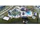 Aerial view of community amenities featuring a lazy river, a pool, and a sandy volleyball court at 4348 Quote St, Kissimmee, FL 34746