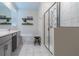 Modern bathroom featuring double sinks, a soaking tub, and a glass-enclosed shower at 4348 Quote St, Kissimmee, FL 34746