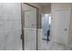 Modern bathroom featuring tiled shower, glass door, and neutral-toned walls at 4348 Quote St, Kissimmee, FL 34746
