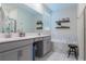 Elegant bathroom showcasing double sinks, a soaking tub, and decor shelves at 4348 Quote St, Kissimmee, FL 34746