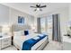 Bright bedroom featuring a ceiling fan, closet, dresser and a comfortable bed at 4348 Quote St, Kissimmee, FL 34746