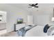 Bright bedroom featuring a ceiling fan, closet, dresser and a TV for modern comfort and style at 4348 Quote St, Kissimmee, FL 34746