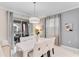 Elegant dining room with contemporary lighting, stylish furniture, and access to outdoor area at 4348 Quote St, Kissimmee, FL 34746