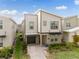 Modern home with neutral siding, a well-kept lawn, and a paved driveway at 4348 Quote St, Kissimmee, FL 34746