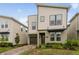 Charming two-story home featuring a modern design with neat front yard landscaping at 4348 Quote St, Kissimmee, FL 34746