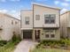 Modern two-story home featuring a brick driveway, an attached garage, and well-maintained landscaping at 4348 Quote St, Kissimmee, FL 34746