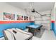 Spacious game room featuring a pool table, air hockey, epoxy floor and superhero wall decor at 4348 Quote St, Kissimmee, FL 34746