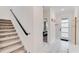 Bright hallway features tile flooring, staircase and a view into the bedroom at 4348 Quote St, Kissimmee, FL 34746