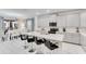 Stylish kitchen features an island with seating, sleek countertops, and stainless steel appliances at 4348 Quote St, Kissimmee, FL 34746