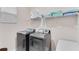 Efficient laundry room equipped with modern washer and dryer, storage shelf and ample lighting at 4348 Quote St, Kissimmee, FL 34746