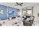 Modern living room with a blue accent wall, contemporary furniture, and tile flooring at 4348 Quote St, Kissimmee, FL 34746