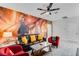 Comfortable living room featuring stylish decor, a ceiling fan, and a large Harry Potter themed wall art at 4348 Quote St, Kissimmee, FL 34746