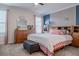 Bright main bedroom showcasing a wooden headboard, soft lighting, and neutral decor at 4348 Quote St, Kissimmee, FL 34746