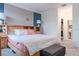 Bright main bedroom with a wooden headboard, soft lighting, and a glimpse into the walk-in closet at 4348 Quote St, Kissimmee, FL 34746