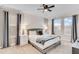 Relaxing main bedroom with a textured accent wall, soft lighting, and neutral color palette at 4348 Quote St, Kissimmee, FL 34746
