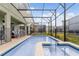 Backyard pool features a screened enclosure, a patio lounge area, and green lawn at 4348 Quote St, Kissimmee, FL 34746