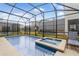Sparkling pool and spa area with a screen enclosure for outdoor enjoyment at 4348 Quote St, Kissimmee, FL 34746