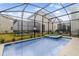 Sparkling pool and spa area with a screen enclosure for outdoor enjoyment at 4348 Quote St, Kissimmee, FL 34746