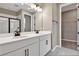 Bathroom featuring a double vanity with white countertops, dark fixtures, and a walk-in closet at 1619 Sugarbelle Cir, Mascotte, FL 34753