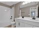 Bathroom with double vanity, white countertop, dark fixtures, and a shower and bathtub combination at 1619 Sugarbelle Cir, Mascotte, FL 34753