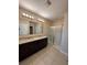 Bathroom with double vanity, granite countertops and shower at 405 Briar Patch Loop, Davenport, FL 33896