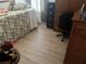 Cozy bedroom with natural light, a comfortable chair, and light colored wood flooring at 806 Ebb Tide Ln, Poinciana, FL 34759