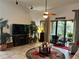 Bright living room with fireplace, large TV, and sliding doors leading to a patio at 806 Ebb Tide Ln, Poinciana, FL 34759