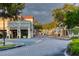 Charming street view featuring brick road, sidewalks, well-manicured trees, and colorful buildings at 806 Ebb Tide Ln, Poinciana, FL 34759