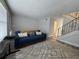 Cozy living room featuring a comfortable blue sofa and stylish area rug at 6062 N Village Cir # Ge, Orlando, FL 32822