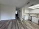 Open-concept living space with modern kitchen and sleek, wood-look floors at 6062 N Village Cir # Ge, Orlando, FL 32822