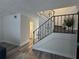 An ornate staircase is the focus with railing and a view of the bathroom at 6062 N Village Cir # Ge, Orlando, FL 32822