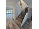 Stylish staircase with decorative iron railing and view to patio at 6062 N Village Cir # Ge, Orlando, FL 32822