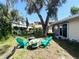 Cozy backyard with furniture under a shady tree, great for relaxing at 1536 Espanola Ave, Holly Hill, FL 32117