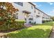 A spacious backyard with well-manicured grass, lush green foliage, a brick patio, and outdoor seating at 8541 Spyglass Ln, Davenport, FL 33896