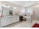 Bathroom features double vanity, soaking tub, and a glass-enclosed shower with gray tile at 8541 Spyglass Ln, Davenport, FL 33896