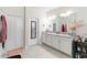 Bathroom includes a double sink with a long mirror at 8541 Spyglass Ln, Davenport, FL 33896