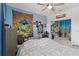 Spacious bedroom featuring a ceiling fan, mirrored closet doors, and colorful mushroom tapestry at 8541 Spyglass Ln, Davenport, FL 33896