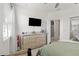 Bedroom featuring a television, ceiling fan, a large dresser and a doorway into a hallway at 8541 Spyglass Ln, Davenport, FL 33896
