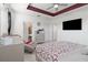 Spacious bedroom with tray ceiling, dresser, and a large TV mounted on the wall at 8541 Spyglass Ln, Davenport, FL 33896