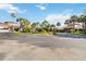 Well-maintained community entrance with mature trees and a roundabout for easy access and flow at 8541 Spyglass Ln, Davenport, FL 33896