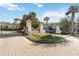 Gated community entrance with lush landscaping and decorative signage, providing security and curb appeal at 8541 Spyglass Ln, Davenport, FL 33896